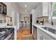 Bright kitchen with stainless steel appliances, counter seating, and hardwood floors at 6741 Evanston Ave, Indianapolis, IN 46220