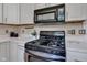 Modern kitchen range with stainless steel appliances and bright white countertops at 6741 Evanston Ave, Indianapolis, IN 46220