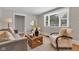 Inviting living room featuring stylish furniture, a unique wood coffee table, and lots of natural light at 6741 Evanston Ave, Indianapolis, IN 46220