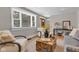 Bright living room with hardwood floors, stylish decor, and large windows for ample sunlight at 6741 Evanston Ave, Indianapolis, IN 46220