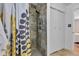 Modern shower with decorative stone-look tile and a glass door; plenty of space at 6741 Evanston Ave, Indianapolis, IN 46220
