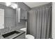 Bathroom features a dark granite countertop, gray cabinets, and a shower with curtain at 6838 Cherry Laurel Ln, Fishers, IN 46038