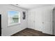 Bedroom showing a modern paint scheme, wood floors, and windows offering plenty of light at 6838 Cherry Laurel Ln, Fishers, IN 46038