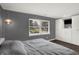 Spacious bedroom with a large window, closet, and hardwood floors at 6838 Cherry Laurel Ln, Fishers, IN 46038