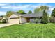 Attractive single-story home with manicured lawn, a two-car garage, and complemented by mature landscaping at 6838 Cherry Laurel Ln, Fishers, IN 46038