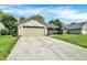 Inviting ranch-style house boasts a long driveway, two-car garage, and lush green lawn under a bright sky at 6838 Cherry Laurel Ln, Fishers, IN 46038