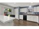 A bright kitchen featuring white cabinets, stainless steel appliances, and modern fixtures at 6838 Cherry Laurel Ln, Fishers, IN 46038