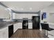 A bright kitchen featuring white cabinets, stainless steel appliances, and modern fixtures at 6838 Cherry Laurel Ln, Fishers, IN 46038