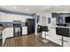 Well-lit kitchen with black appliances, breakfast bar and dark wood flooring at 6838 Cherry Laurel Ln, Fishers, IN 46038