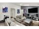 Open-concept living area features hardwood floors, comfortable seating, and contemporary design elements at 6838 Cherry Laurel Ln, Fishers, IN 46038