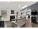 Bright, open living room with fireplace, vaulted ceilings, skylight and seamless flow into kitchen area at 6838 Cherry Laurel Ln, Fishers, IN 46038