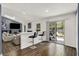 Open living space with bar seating, sliding doors to outside, wood floors, and view of the living room at 6838 Cherry Laurel Ln, Fishers, IN 46038
