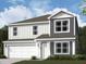Charming two-story home with a two-car garage and a well-manicured lawn at 6912 Rawlings Ln, Indianapolis, IN 46221
