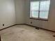 Cozy bedroom with a neutral color palette and natural light from a single window at 7042 Colita More Ct, Indianapolis, IN 46254