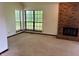 Spacious living room with a brick fireplace, plush carpeting, and large windows at 7042 Colita More Ct, Indianapolis, IN 46254