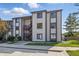 Condominium exterior featuring traditional siding, stairwell entry, and green space at 8158 Shorewalk Dr # F, Indianapolis, IN 46236