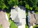Aerial view of a home with a grey roof, surrounded by mature trees and a landscaped yard at 829 Pioneer Woods Dr, Indianapolis, IN 46224