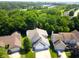 Charming suburban home featuring mature trees, a two-car garage, and a manicured lawn at 829 Pioneer Woods Dr, Indianapolis, IN 46224