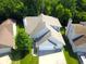 Aerial view of a single-Gathering home with a large yard and attached garage at 829 Pioneer Woods Dr, Indianapolis, IN 46224