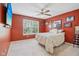 Inviting bedroom with a comfortable bed, natural light from the window and red colored walls at 829 Pioneer Woods Dr, Indianapolis, IN 46224