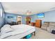 Spacious bedroom with ceiling fan, television, adjacent sitting area, and door leading to another room at 829 Pioneer Woods Dr, Indianapolis, IN 46224