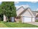 Beautiful exterior view of a charming home with a lush green lawn and mature trees creating a serene and inviting atmosphere at 829 Pioneer Woods Dr, Indianapolis, IN 46224