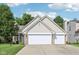 Charming two-story home featuring a two-car garage, brick accents, and a well-manicured lawn, offering an inviting curb appeal at 829 Pioneer Woods Dr, Indianapolis, IN 46224