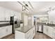 Bright kitchen showcasing white cabinets, stainless appliances, a center island and open access to other living areas at 829 Pioneer Woods Dr, Indianapolis, IN 46224
