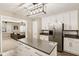 Modern kitchen features stainless steel appliances, white cabinetry, and an island with gray countertop at 829 Pioneer Woods Dr, Indianapolis, IN 46224