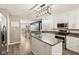 Open kitchen with white cabinets, stainless steel appliances, center island and adjacent dining area at 829 Pioneer Woods Dr, Indianapolis, IN 46224