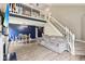 Spacious living room with modern decor, a cozy sofa, stylish lighting, and an open staircase leading to a charming loft area at 829 Pioneer Woods Dr, Indianapolis, IN 46224