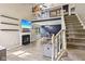 Bright and inviting living room featuring a fireplace, loft area, and a staircase, creating a warm and welcoming atmosphere at 829 Pioneer Woods Dr, Indianapolis, IN 46224