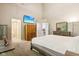 Spacious main bedroom offers bright lighting, television, neutral walls and carpet, with nearby bathroom entrances at 829 Pioneer Woods Dr, Indianapolis, IN 46224