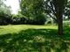 Spacious backyard features mature trees and lush green grass, perfect for outdoor activities at 8425 E 82Nd E St, Indianapolis, IN 46256