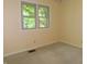 A simple bedroom with neutral walls, a large window, and carpet floors at 8425 E 82Nd E St, Indianapolis, IN 46256