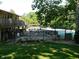 Fenced community pool area with plenty of lounge chairs, surrounded by trees at 8425 E 82Nd E St, Indianapolis, IN 46256