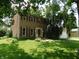 Traditional two-story home with a red front door, wood siding, and a well-manicured lawn at 8425 E 82Nd E St, Indianapolis, IN 46256