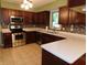 Modern kitchen featuring stainless steel appliances, dark cabinets, and tile flooring at 8425 E 82Nd E St, Indianapolis, IN 46256