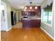 An open kitchen features stainless steel appliances, dark cabinetry, and an eat-in breakfast bar with hardwood floors at 8425 E 82Nd E St, Indianapolis, IN 46256