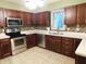 Modern kitchen with stainless steel appliances, beautiful backsplash, and tile flooring at 8425 E 82Nd E St, Indianapolis, IN 46256