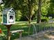 Quaint little library box with a bicycle rack surrounded by lush greenery at 8425 E 82Nd E St, Indianapolis, IN 46256