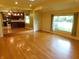 A brightly lit living room shows hardwood floors, natural light from the windows, and an open view to the kitchen at 8425 E 82Nd E St, Indianapolis, IN 46256
