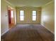 Bright living room with carpet flooring, featuring a view of the front entryway and natural lighting at 8425 E 82Nd E St, Indianapolis, IN 46256