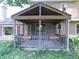 Inviting covered porch with ornate details, perfect for relaxing and enjoying the outdoors at 8425 E 82Nd E St, Indianapolis, IN 46256
