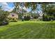 Expansive backyard with lush green grass and mature trees, offering privacy and space at 8525 Winding Ridge Rd, Indianapolis, IN 46217