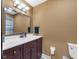 Bathroom featuring a vanity with a white countertop and a well-lit mirror at 8525 Winding Ridge Rd, Indianapolis, IN 46217