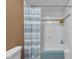 Clean white bathroom with a tiled shower-tub combination and blue accents at 8525 Winding Ridge Rd, Indianapolis, IN 46217