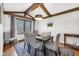 Dining room featuring wood beam ceiling, decorative chandelier, and window views at 8525 Winding Ridge Rd, Indianapolis, IN 46217