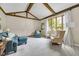 Cozy living room showcasing vaulted ceilings, exposed wood beams, and large windows at 8525 Winding Ridge Rd, Indianapolis, IN 46217