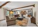 Comfortable living room featuring wooden beams, plush seating, and access to the dining area at 8525 Winding Ridge Rd, Indianapolis, IN 46217